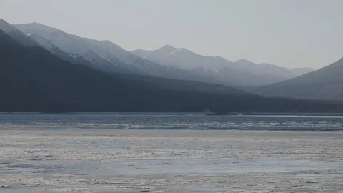 Beautiful mountain ranges behind the flowing river Stock Footage 145275643