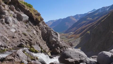 A beautiful mountain river flows through a scenic valley in the North Caucasus, Stock Footage 320854089