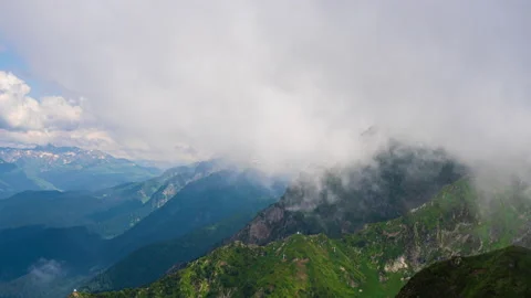 Beautiful mountain slopes covered with white clouds, nature landscape. Stock Footage 136508161