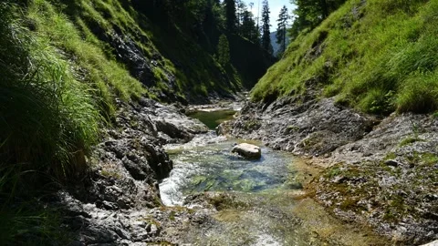 A beautiful mountain stream with pools in summer sunlight Video stock 260845793