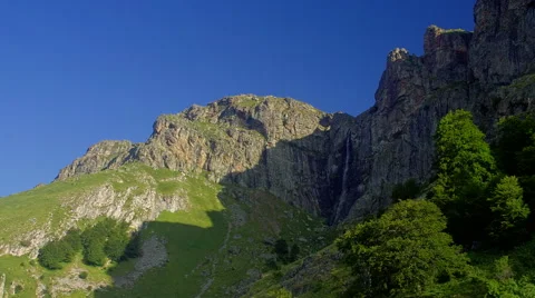 Beautiful mountain time lapse with moving shadows and clouds in blue sky Stock Footage 61111991