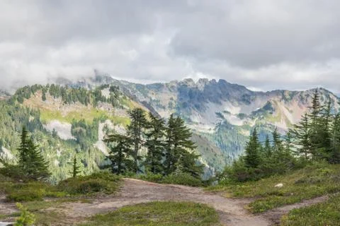 Beautiful mountain view with a cloudy sky on the background Stock Photos