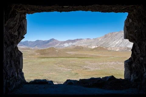 A beautiful mountain view seen through the window of a rustic cabin, captur.. Stock Photos