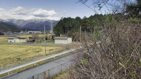 Beautiful mountain views over rice fields in Japan and quiet rural scenery Stock Footage 304845976