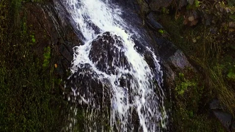 Beautiful mountain waterfall against the backdrop of rocks and green plants Stock Footage 290165806