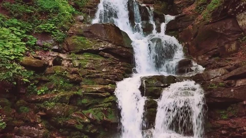 Beautiful mountain waterfall surrounded by pine and fir trees Stock Footage 80171729