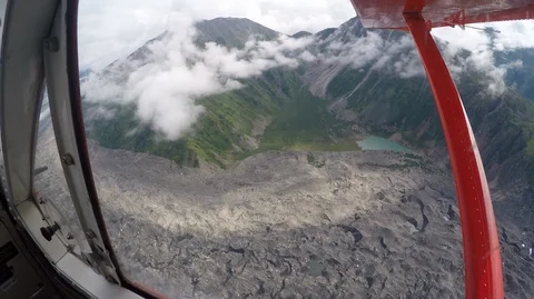 Beautiful mountains and clouds from plane window Stock Footage 99078153