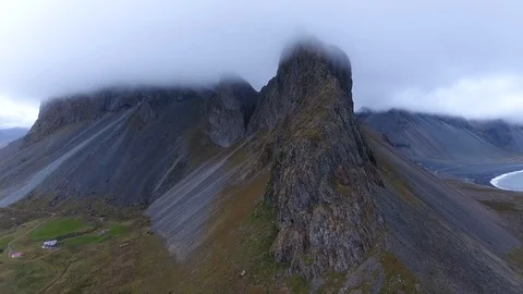 Beautiful mountains covered in clouds next to a street in Iceland Stock Footage 86152125