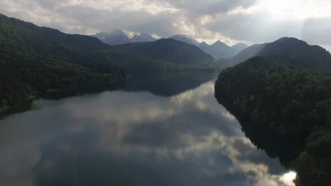 Beautiful mountains with green dense forest and lake on a sunny day Stock Footage 116185157