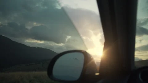 Beautiful mountains landscape from window of car. Amazing warm sunset Stock Footage 284749625