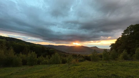 Beautiful mountains with sunset clouds at spring or summer time Stock Footage 330677126