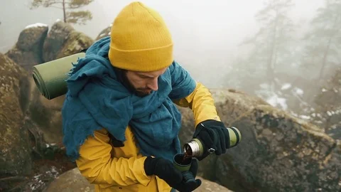 Beautiful mountains in winter time. Man with beard, wearing yellow winter Stock Footage 84656102