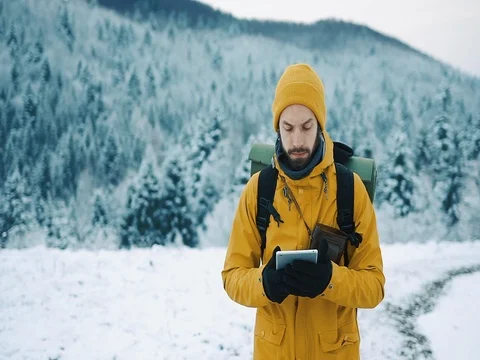 Beautiful mountains in winter time. Man with beard, wearing yellow winter Stock Footage 84719151