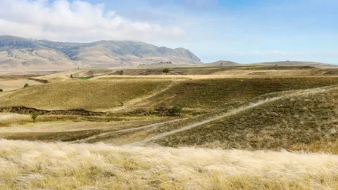 Beautiful movement of clouds over Mount Meganom, hills and a valley Stock Footage 156695438