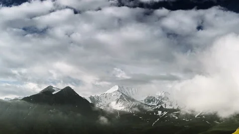 Beautiful movement of clouds over mountain peaks. Sunny day. Time Lapse. Stock Footage 163288832
