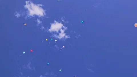 Beautiful multi-colored balloons fly in the blue sky Stock Footage 102724234
