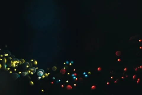 Beautiful multi colored bokeh background on a dark. Stock Photos