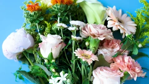 Beautiful multi colored bouquet on a blue background close-up. Stock Footage 201125855