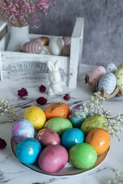 Beautiful multi -colored decorated Easter eggs and a cute white Easter rabbit Stock Photos