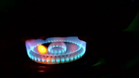 A beautiful multi-colored fire burns with tongues of flame from a gas stove Stock Footage 332063386