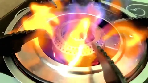 A beautiful multi-colored fire ignites with tongues of flame and burns from gas Stock Footage 332063099