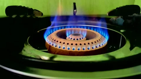 A beautiful multi-colored flame burns on a gas stove burner in slow motion Stock Footage 332063432