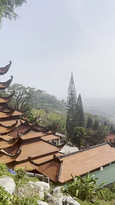 A beautiful multi-layered Buddhist pagoda stands tall on a hillside. Stock Footage 337354285