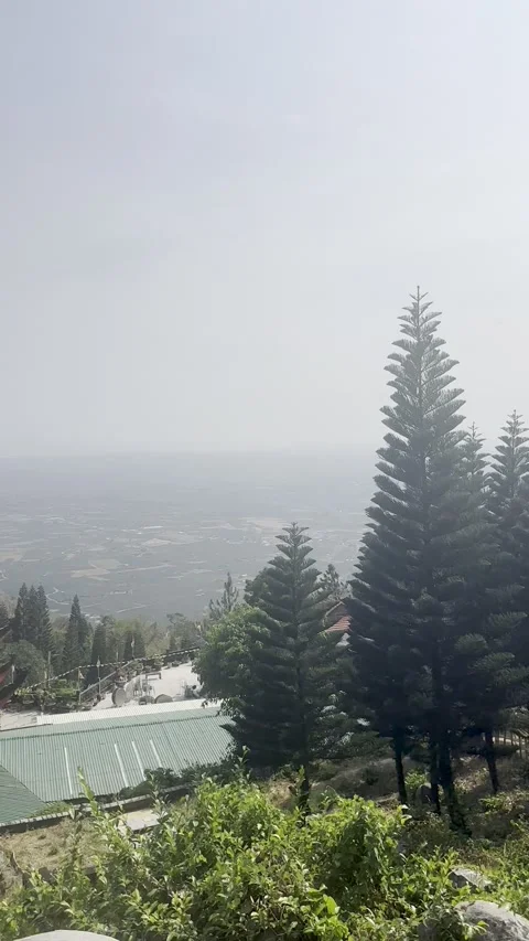 A beautiful multi-layered Buddhist pagoda stands tall on a hillside. Stock Footage 337354286