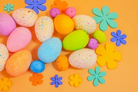Beautiful multicoloured Easter eggs on.an orange background Stock Photos