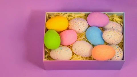 Beautiful multicoloured Easter eggs in a purple box vibrant coloured Easter egg Foto stock