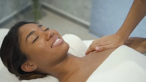 Beautiful multiethnic female model is getting shoulder massage treatment. Stock Footage 103744732