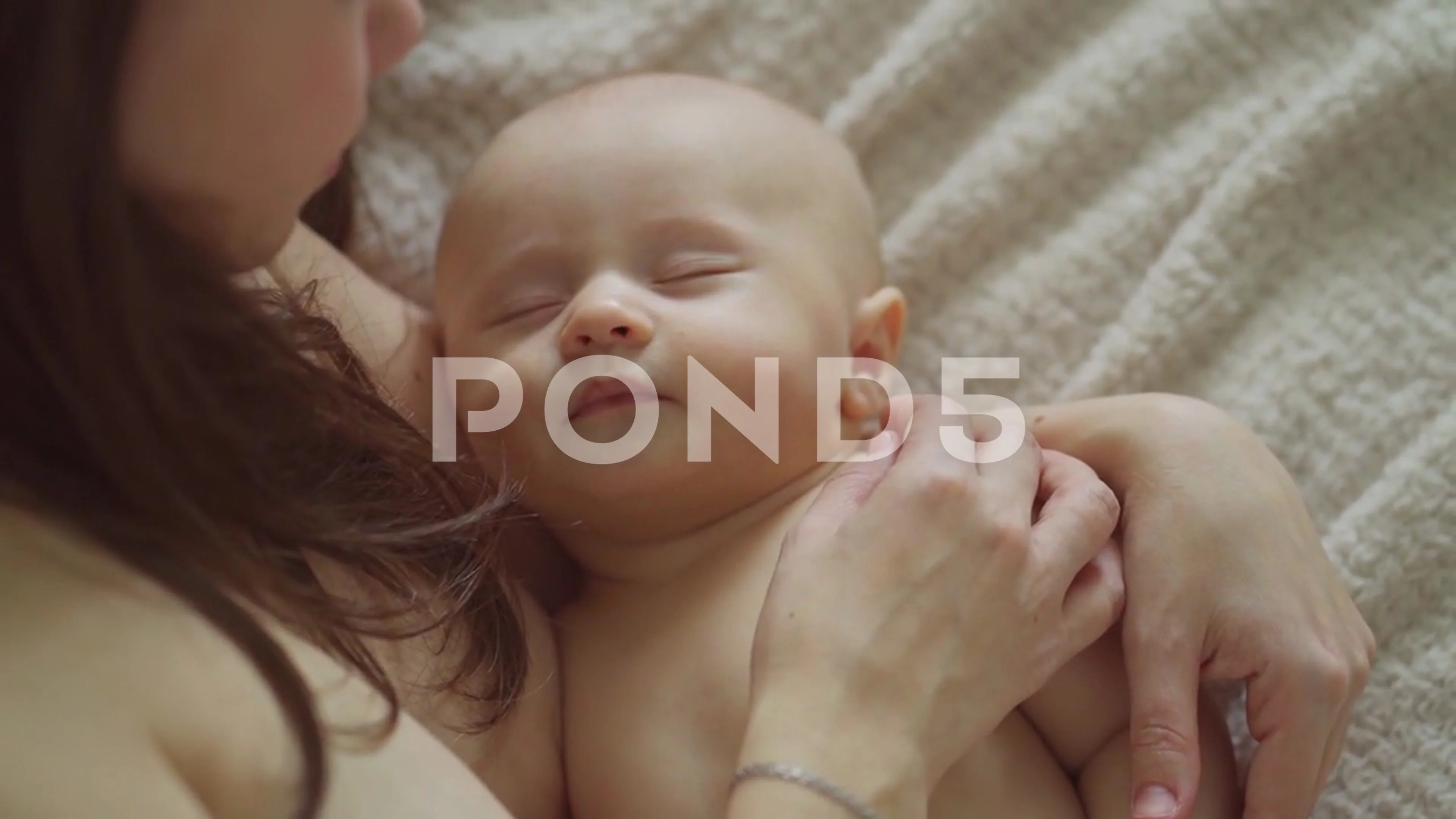 a beautiful naked baby sleeps in his mot... | Stock Video | Pond5