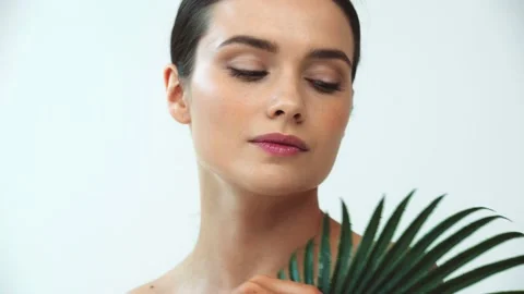 Beautiful naked woman holding leaf of tr... | Stock Video | Pond5