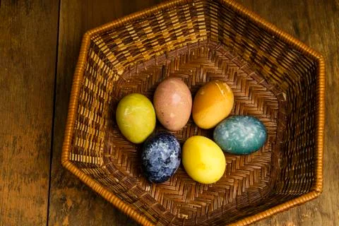 Beautiful natural colored happy easter eggs in basket Stock Photos