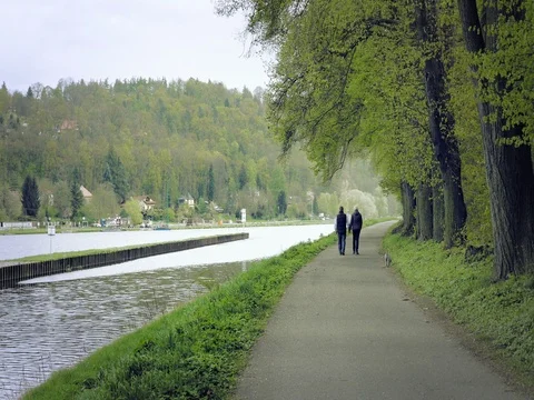 Beautiful natural valley with river, path with two walkers, jogging. Stock Footage 75003920