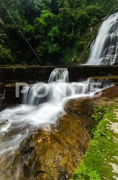 Beautiful in nature, amazing cascading tropical waterfall. wet and mossy rock Stock Photos