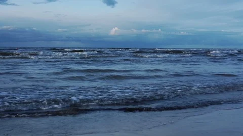 Beautiful navy ocean with waves rolling on sand beach Stock Footage 120246184