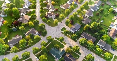 Beautiful neighborhood in summer at sunrise, moving aerial view Stock Footage
