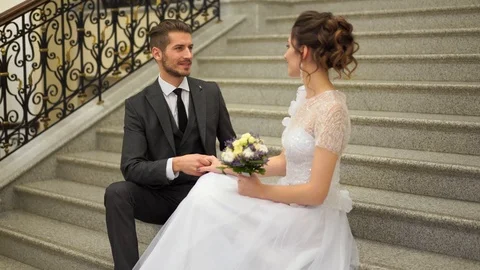 Beautiful newlywed couple posing in the chic expensive indoor on the steps Stock Footage 102722067