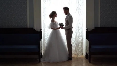 Beautiful newlywed couple posing in the chic expensive indoor. the camera Stock Footage 103143103