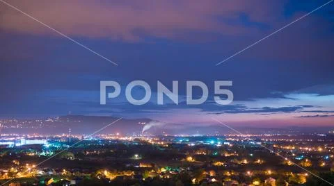 The beautiful night view on the city against the background of cloud stream.. Stock Photos