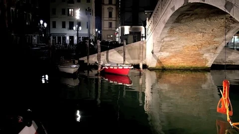 A beautiful night view of an old bridge and little boats in an ancient town Stock Footage 73200104