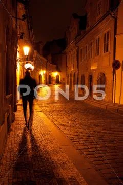 A beautiful night view of the street and the shadow of a man in prague Stock Photos