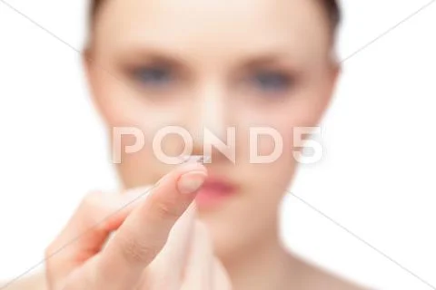 Beautiful nude model holding contact lens Stock Photos