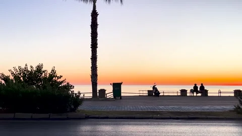Beautiful Ocean Sunset during sunset in a coastal city from the pavment Stock Footage 297431244