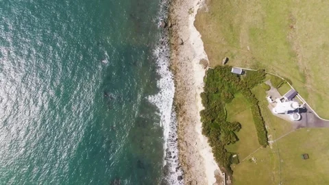 A beautiful ocean view with a house in the background Stock Footage 297950477