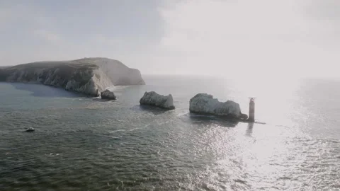 A beautiful ocean view with a lighthouse in the distance Stock Footage 297078618
