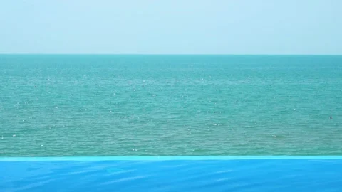 Beautiful Ocean View from the Outdoor Infinity Pool of the Resort Hotel on a Sun Stock Footage 217371472