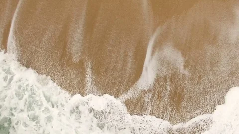 Beautiful ocean waves and splashes on a sandy beach in Nazar , Portugal. Aerial Video stock 80900047