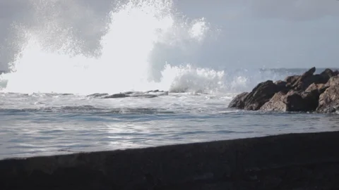Beautiful ocean waves cascade falling on rocks in natural pool one by one Stock-Footage 128736025